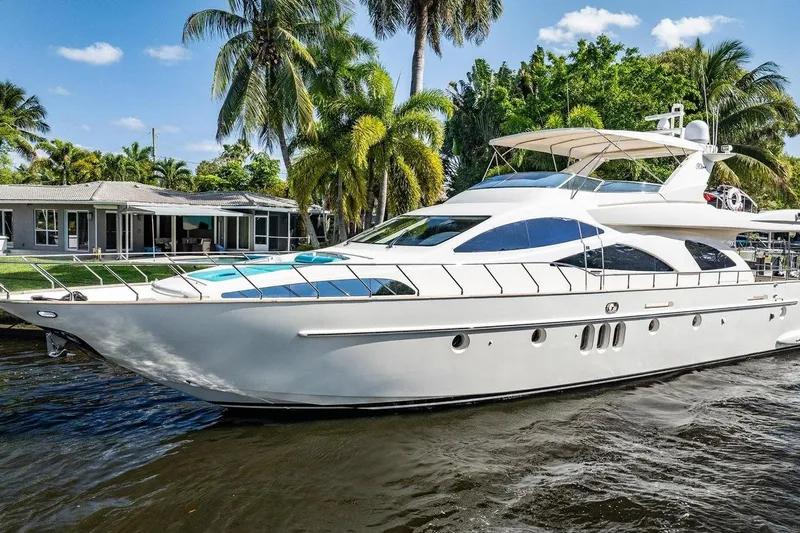 The Cure Yacht Photos Pics Luxurious 2003 Azimut 80 Carat yacht docked near tropical waterfront home.