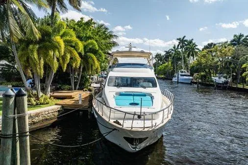 The Cure Yacht Photos Pics 2003 Azimut 80 Carat yacht docked in a tropical canal setting.