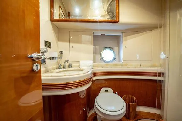 The Cure Yacht Photos Pics Luxurious bathroom interior of 2003 Azimut 80 Carat yacht with elegant wood finishes.