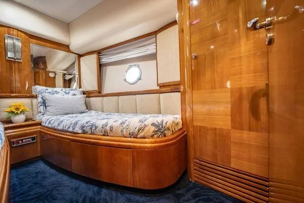 The Cure Yacht Photos Pics Luxurious cabin interior of 2003 Azimut 80 Carat yacht with elegant wood finish.