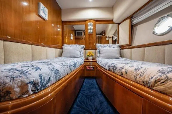 The Cure Yacht Photos Pics Luxurious twin cabin interior of 2003 Azimut 80 Carat yacht with elegant wood finish.