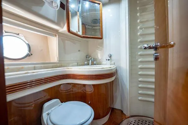 The Cure Yacht Photos Pics Luxurious bathroom in 2003 Azimut 80 Carat yacht with elegant wood and marble finishes.