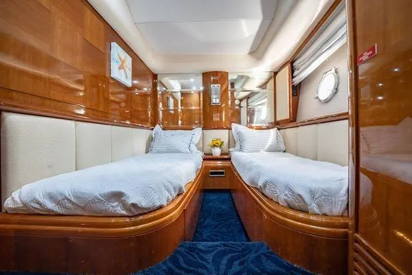 The Cure Yacht Photos Pics Luxurious twin cabin interior of 2003 Azimut 80 Carat yacht with elegant wood finish.
