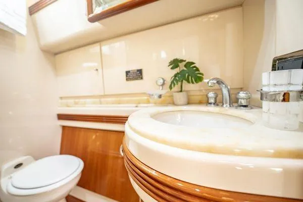 The Cure Yacht Photos Pics Luxurious bathroom in 2003 Azimut 80 Carat yacht with elegant fixtures and decor.