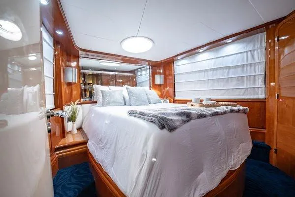 The Cure Yacht Photos Pics Luxurious bedroom interior of 2003 Azimut 80 Carat yacht with elegant wood paneling.