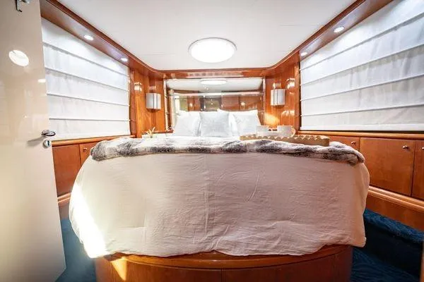 The Cure Yacht Photos Pics Luxurious bedroom interior of 2003 Azimut 80 Carat yacht with elegant wood paneling.