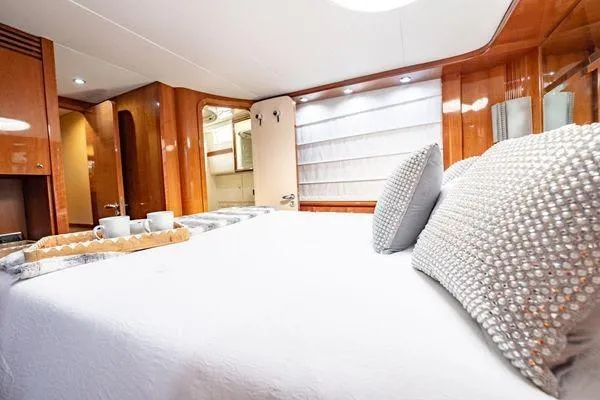 The Cure Yacht Photos Pics Luxurious bedroom interior of 2003 Azimut 80 Carat yacht with elegant decor and plush bedding.