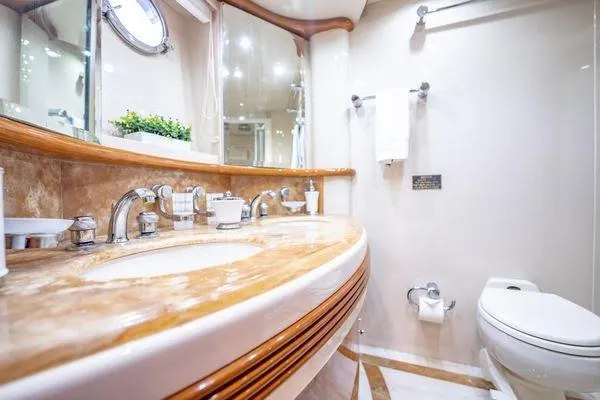 The Cure Yacht Photos Pics Luxurious bathroom in 2003 Azimut 80 Carat yacht with elegant fixtures and marble countertop.
