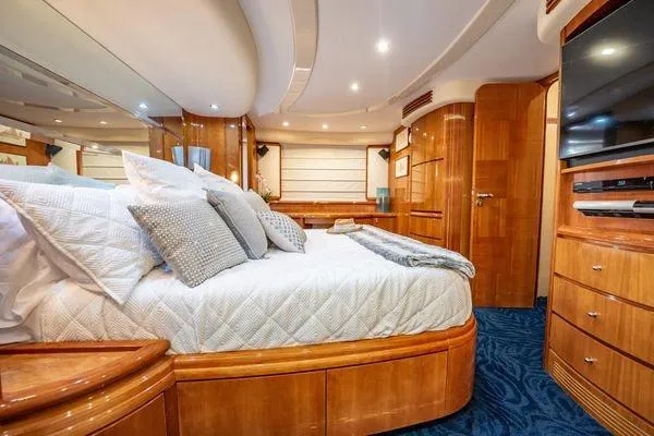 The Cure Yacht Photos Pics Luxurious bedroom interior of 2003 Azimut 80 Carat yacht with elegant wood finishes.
