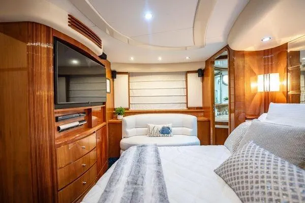 The Cure Yacht Photos Pics Luxurious interior of 2003 Azimut 80 Carat yacht with elegant wood finishes and cozy seating.