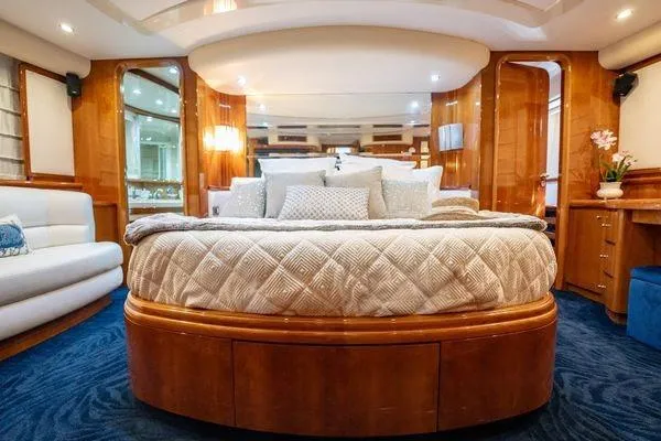 The Cure Yacht Photos Pics Luxurious bedroom interior of 2003 Azimut 80 Carat yacht with elegant wood finishes.