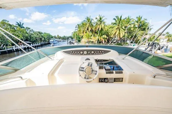 The Cure Yacht Photos Pics Cockpit view of 2003 Azimut 80 Carat yacht with tropical waterfront backdrop.