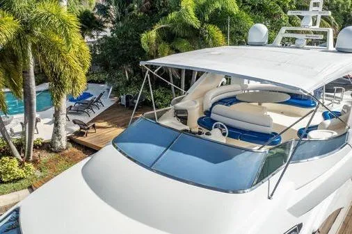 The Cure Yacht Photos Pics Luxury 2003 Azimut 80 Carat yacht docked near tropical poolside setting.