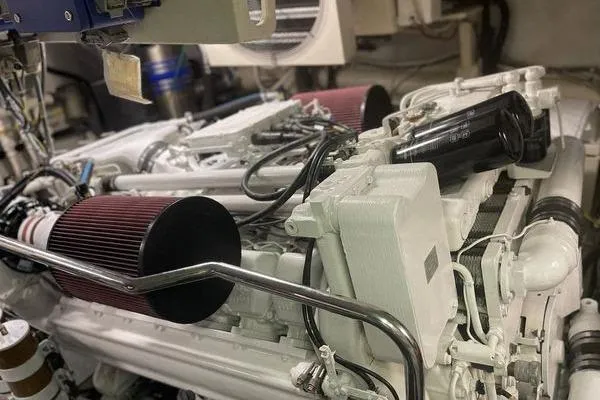 The Cure Yacht Photos Pics Engine room of a 2003 Azimut 80 Carat yacht, showcasing mechanical components and filters.