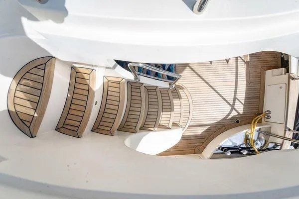 The Cure Yacht Photos Pics Staircase on 2003 Azimut 80 Carat yacht with elegant wooden deck design.