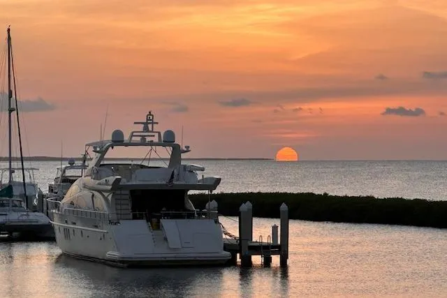 The Cure Yacht Photos Pics Azimut 80 Carat yacht at sunset, 2003 model, docked by serene waters.