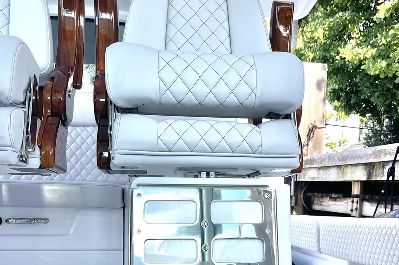  Yacht Photos Pics Luxurious seating on 2024 HCB 48 Campeon boat with quilted upholstery and wooden accents.