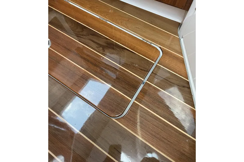  Yacht Photos Pics Polished wooden deck of 2024 HCB 48 Campeon boat, featuring sleek design.