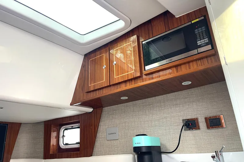  Yacht Photos Pics 2024 HCB 48 Campeon yacht interior with microwave, wooden cabinets, and modern appliances.