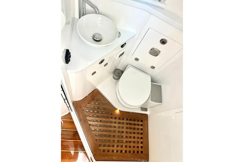  Yacht Photos Pics Luxurious bathroom in 2024 HCB 48 Campeon boat with modern fixtures and wooden flooring.