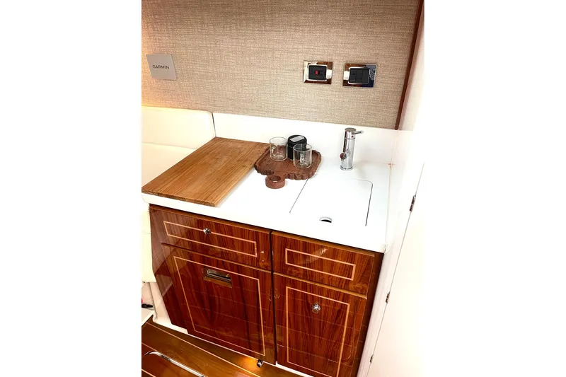  Yacht Photos Pics Luxurious 2024 HCB 48 Campeon yacht interior with elegant wood cabinetry and modern sink.