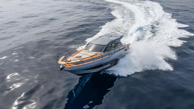  Yacht Photos Pics 2025 Hanover 415 yacht cruising on open water, creating a dynamic wake.