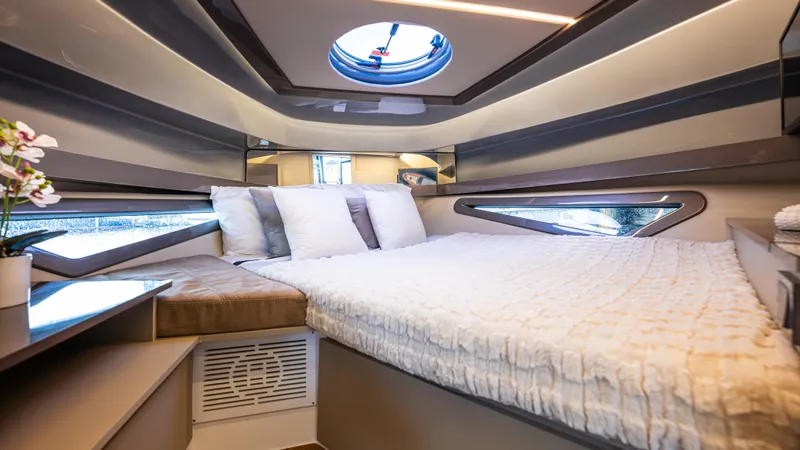  Yacht Photos Pics Luxurious cabin interior of 2025 Hanover 415 yacht with modern bedding and porthole.