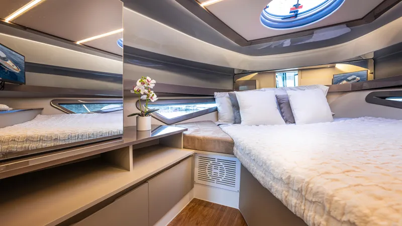  Yacht Photos Pics Luxurious cabin interior of 2025 Hanover 415 yacht with modern design and cozy bedding.