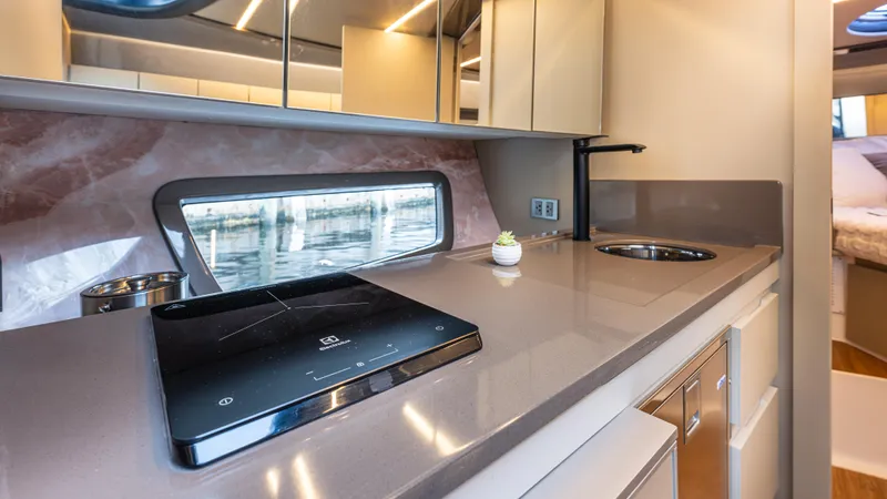  Yacht Photos Pics Modern kitchen interior in 2025 Hanover 415 yacht with sleek countertops and appliances.