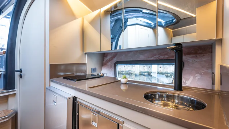  Yacht Photos Pics Modern kitchen interior in 2025 Hanover 415 RV, featuring sleek design and compact appliances.