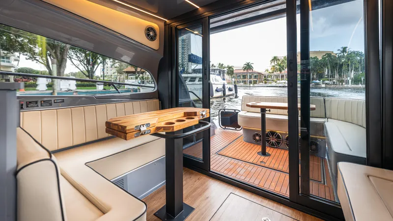  Yacht Photos Pics Luxurious interior of 2025 Hanover 415 yacht with elegant seating and wooden table.