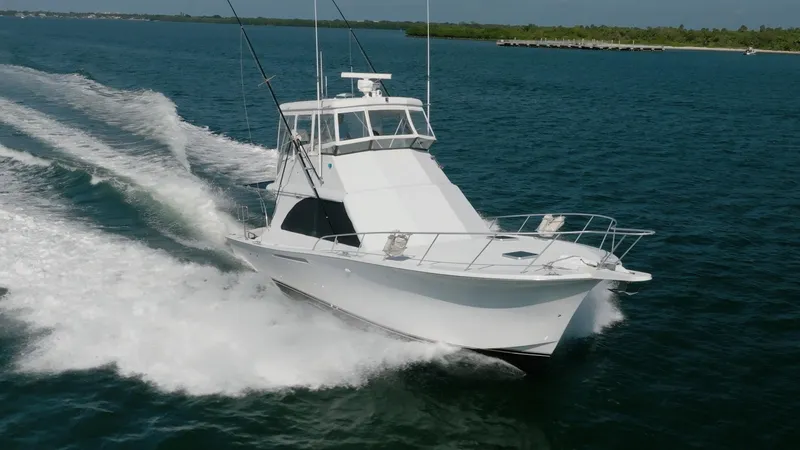 Denise Catherine Yacht Photos Pics 1991 Jersey 42 Convertible Sportfisherman cruising on open water.