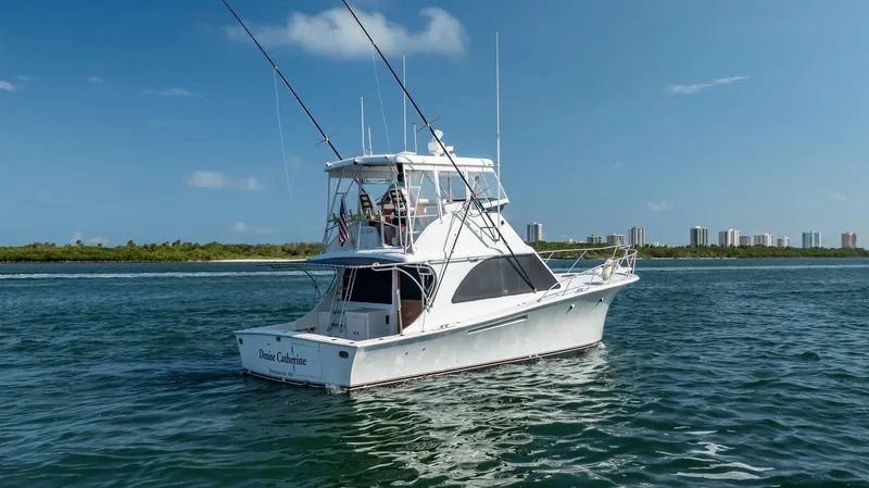 Denise Catherine Yacht Photos Pics 1991 Jersey 42 Convertible Sportfisherman boat on calm water, clear sky background.