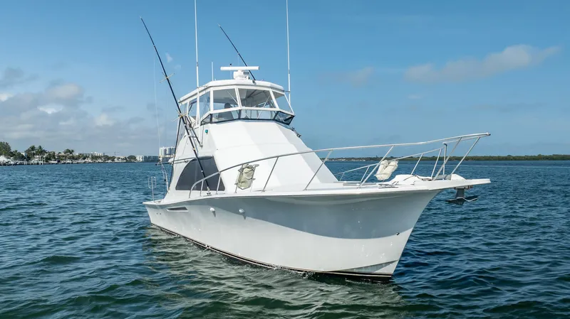 Denise Catherine Yacht Photos Pics 1991 Jersey 42 Convertible Sportfisherman boat on calm water under blue sky.