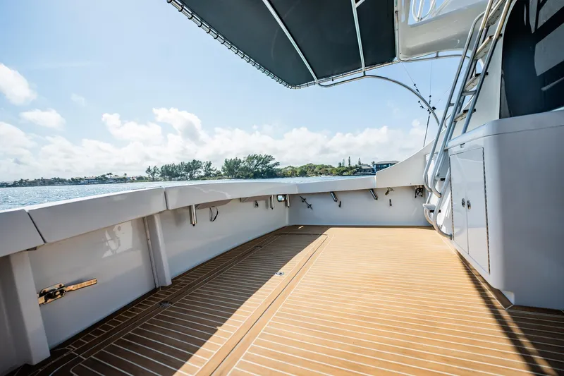 Denise Catherine Yacht Photos Pics 1991 Jersey 42 Convertible Sportfisherman boat deck with wooden flooring and canopy.