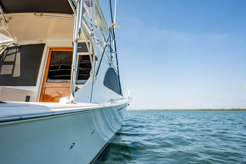 Denise Catherine Yacht Photos Pics 1991 Jersey 42 Convertible Sportfisherman on calm water under clear blue sky.