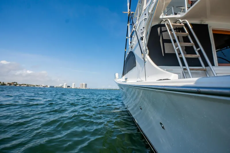 Denise Catherine Yacht Photos Pics 1991 Jersey 42 Convertible Sportfisherman on calm water, clear sky background.