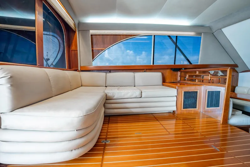 Denise Catherine Yacht Photos Pics Luxurious interior of 1991 Jersey 42 Convertible Sportfisherman with plush seating and wooden flooring.