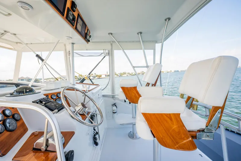 Denise Catherine Yacht Photos Pics 1991 Jersey 42 Convertible Sportfisherman helm with wooden accents and ocean view.
