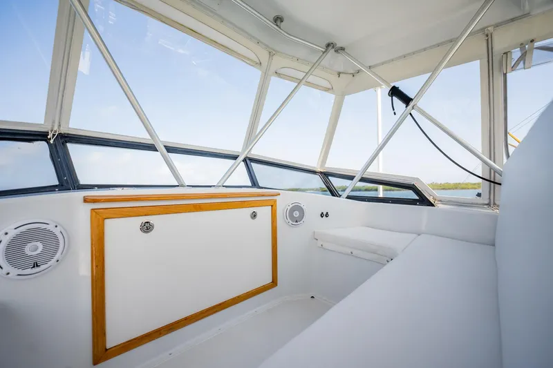 Denise Catherine Yacht Photos Pics Interior of 1991 Jersey 42 Convertible Sportfisherman, featuring white seating and wood accents.