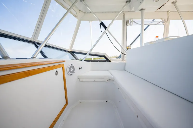 Denise Catherine Yacht Photos Pics Interior of 1991 Jersey 42 Convertible Sportfisherman boat, featuring white seating and wood accents.