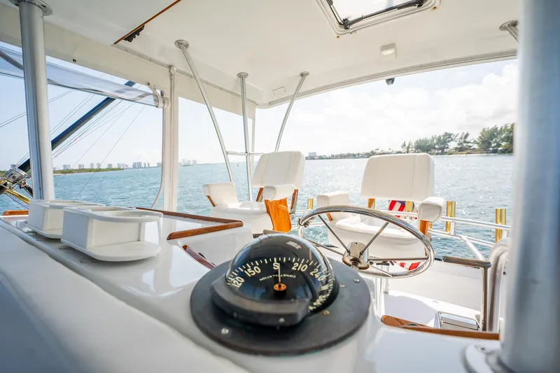 Denise Catherine Yacht Photos Pics Interior view of 1991 Jersey 42 Convertible Sportfisherman yacht with steering wheel and compass.