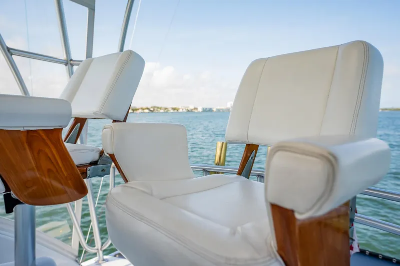 Denise Catherine Yacht Photos Pics Luxury seating on 1991 Jersey 42 Convertible Sportfisherman yacht, overlooking serene waters.