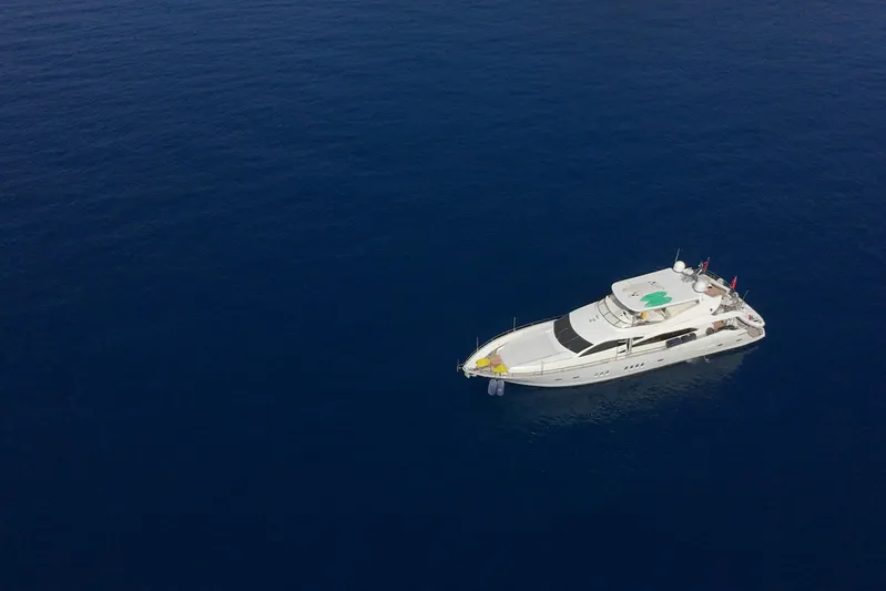 Swordfish 68 Yacht Photos Pics Aerial view of 2009 Sunseeker 90 Yacht on calm blue sea.