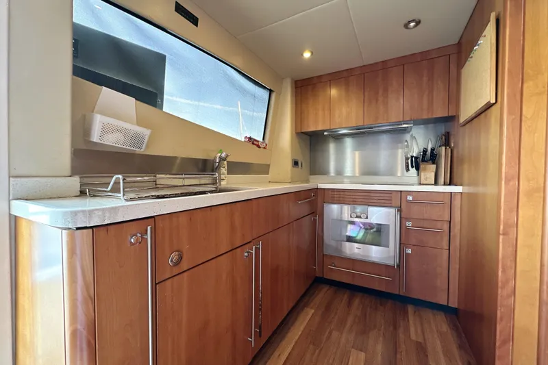 Swordfish 68 Yacht Photos Pics Luxurious kitchen interior of 2009 Sunseeker 90 Yacht with wooden cabinetry and modern appliances.