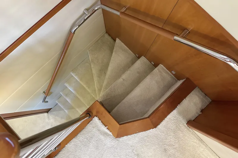 Swordfish 68 Yacht Photos Pics Staircase with wooden handrails and carpeted steps on a 2009 Sunseeker 90 Yacht.