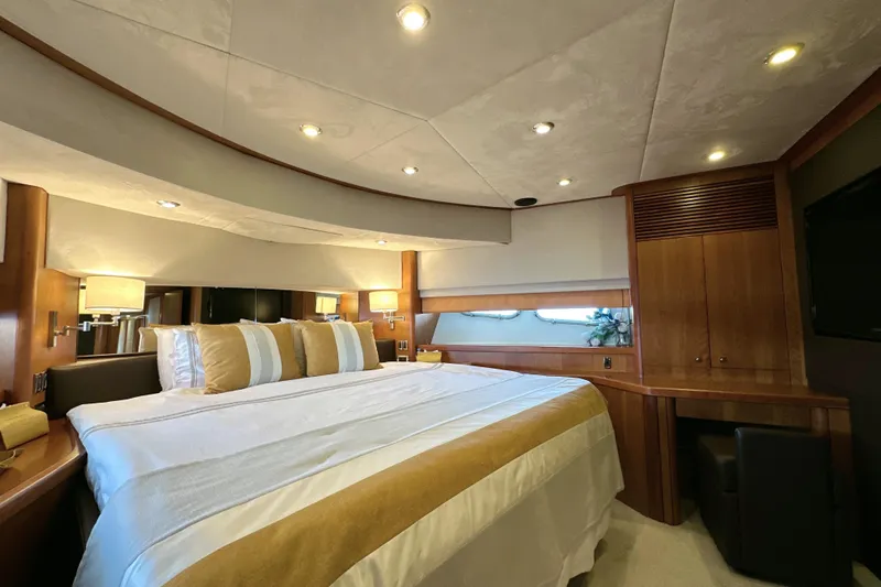 Swordfish 68 Yacht Photos Pics Luxurious bedroom interior of 2009 Sunseeker 90 Yacht with elegant wood finishes.