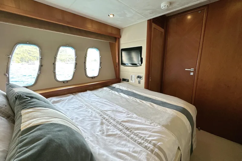 Swordfish 68 Yacht Photos Pics Luxurious bedroom interior of 2009 Sunseeker 90 Yacht with ocean view windows.
