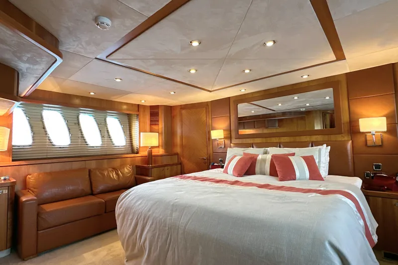 Swordfish 68 Yacht Photos Pics Luxurious bedroom interior of 2009 Sunseeker 90 Yacht with elegant decor and ambient lighting.