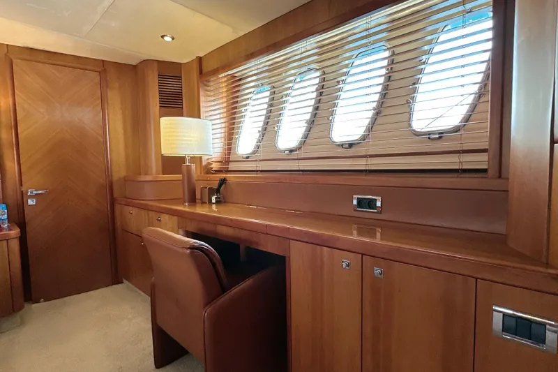 Swordfish 68 Yacht Photos Pics Luxurious interior of 2009 Sunseeker 90 Yacht with wooden furnishings and porthole windows.